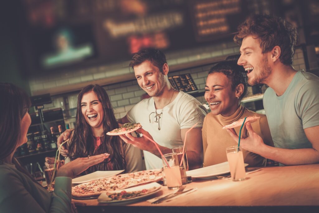 Cheerful Multiracial Friends Having Fun Eating Pizza